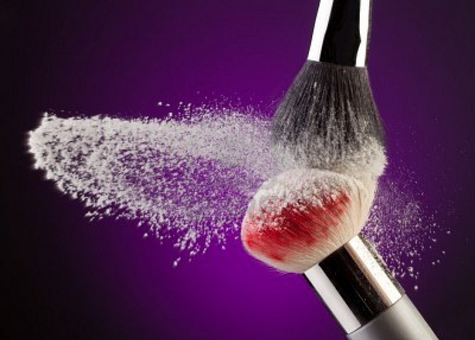 10142828-two-makeup-brushes-with-powder-flying-on-purple